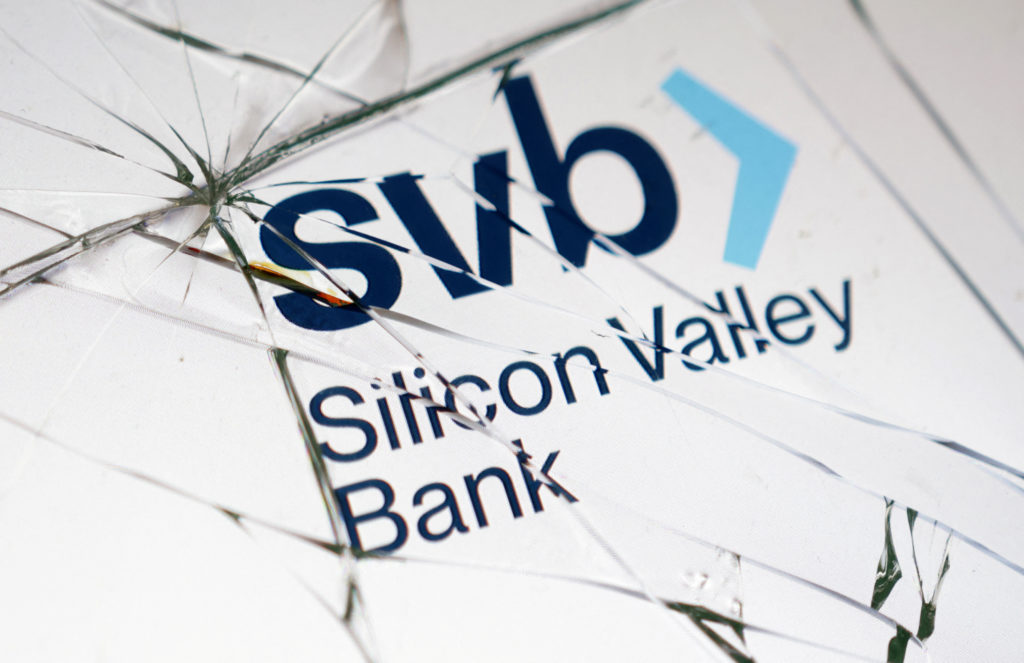 Silicon Valley Bank (SVB) logo is seen through broken glass in this picture illustration taken March 16, 2023. REUTERS/Dado Ruvic/Illustration